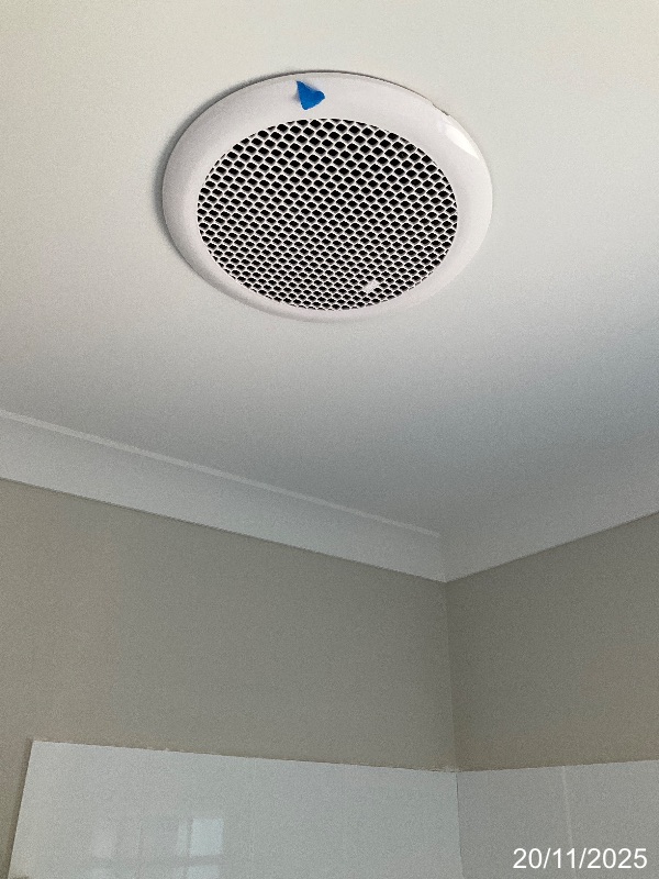 Bathroom ceiling exhaust fan marked with blue inspection tape