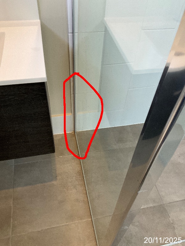Lower shower-screen and wall junction marked for a reported leak